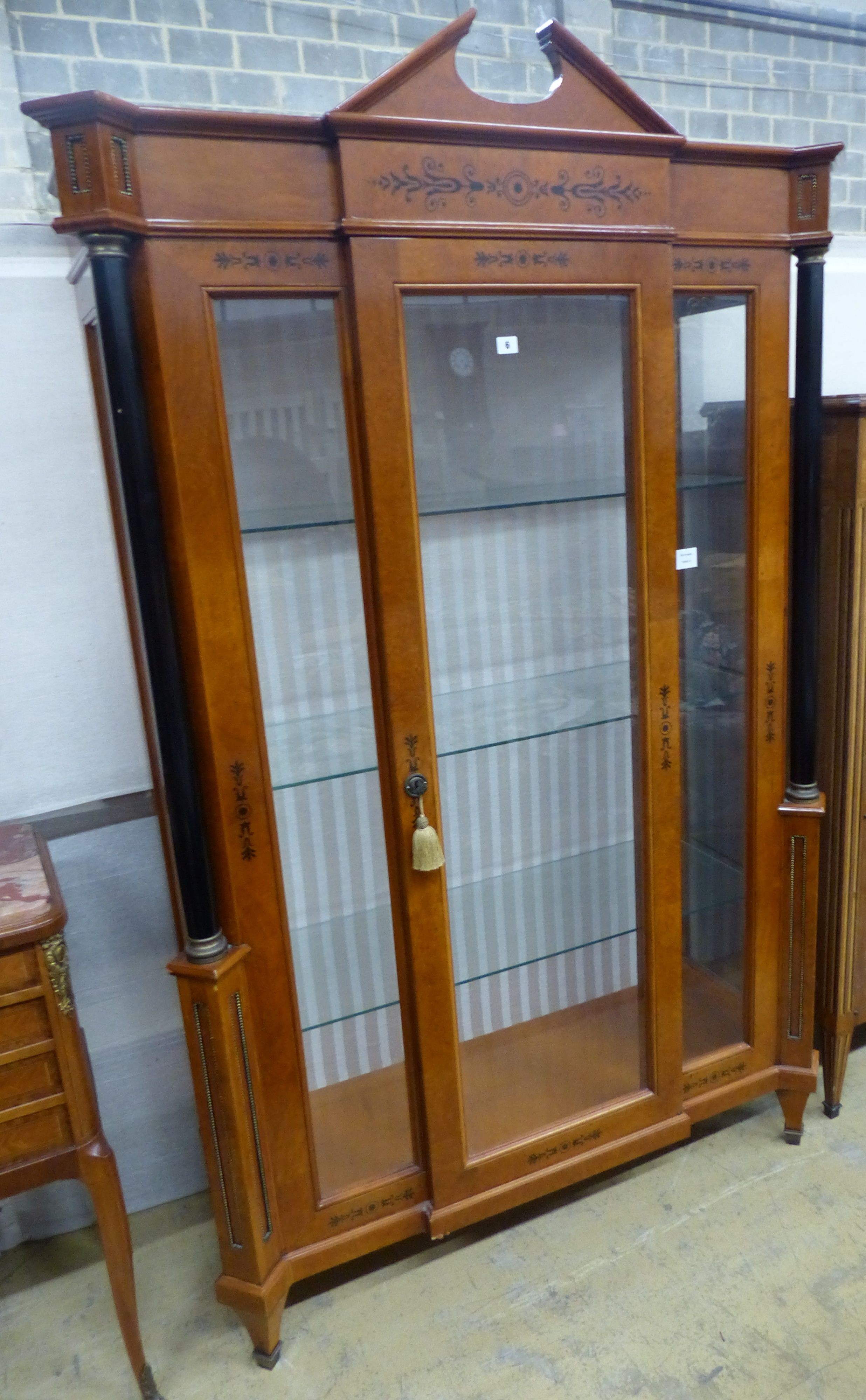 A Biedermeier style ebony inlaid mahogany breakfront display cabinet, W.120cm D.47cm H.197cm